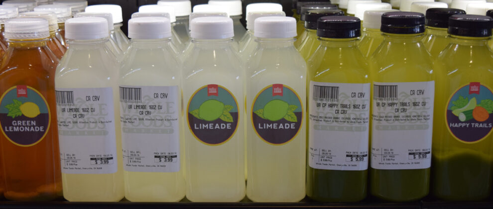 Whole Foods Market Juices with complex and simple labels alternatively facing forward.