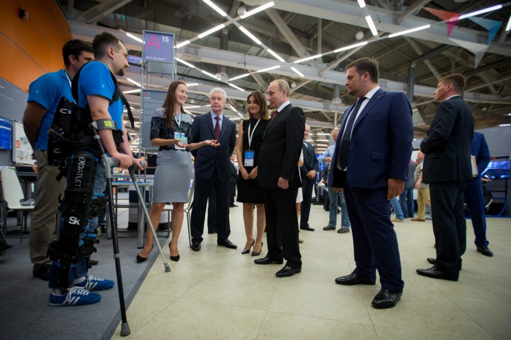 ExoAtlet CEO Ekaterina Bereziy telling Vladimir Putin about her company's exoskeletons while one is demonstrated. Photo: Kremlin.ru,